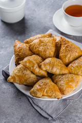 Plate with delicious samosas samsa with meat on gray background, top view. Uzbek food