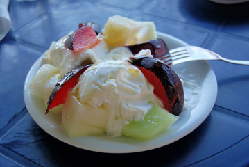 Fresh greek yogurt with melon and plum for dessert