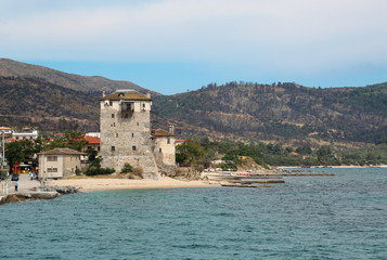 Fototapeta na wymiar Old tower at the beach in Ouranoupoli, Athos peninsula, Chalkidiki, Greece