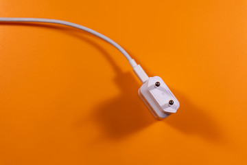 universal charger in white on a orange background