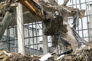 Demolish of an old house. Hydraulic excavator destroys a building