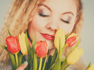 Pretty woman with red yellow tulips bunch