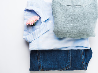 Folded female clothes on white. Fashion flat lay