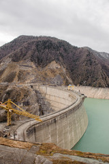 Obraz na płótnie Canvas GEORGIA, SVANETI, MESTIA - FEBRUARY 01, 2019: View on the Enguri Dam with blue water