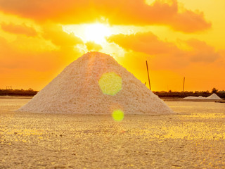 Heap of sea salt in a field prepared for harvest. Mass of salt in the salt sea farm