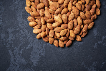 almond on black table  with copy space ,Top view