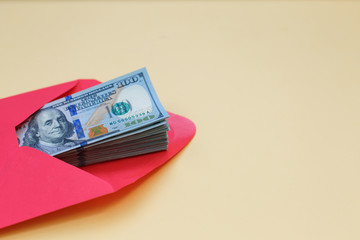 Dollar money in the red envelope. bonus, reward, benefits concept.