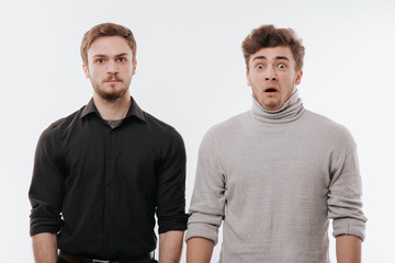 two young men, a concept of emotions, scared and quiet,  isolated white background, copy space,...
