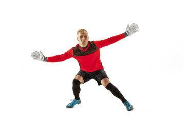 Goalkeeper ready to save on white studio background. Soccer football concept