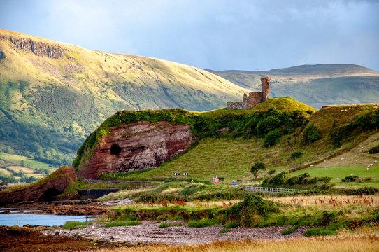 Ruins of medieval Red Bay Castle at western coast of County Antrim, Northern Ireland, UK, and a cliff near Glenariff, Watrerfoot and Cushendall at coast road A2, a.k.a. Causeway Coastal Route