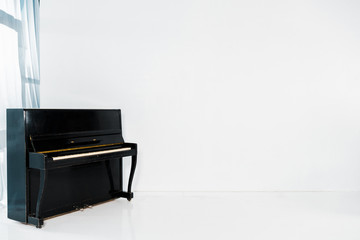 black piano on white background with copy space