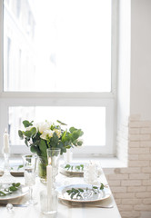 Beautiful festive table setting with elegant white flowers and cutlery, dinner table decoration 