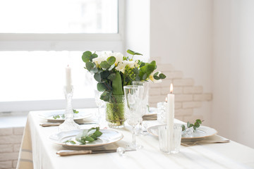 Beautiful festive table setting with elegant white flowers and cutlery, dinner table decoration 