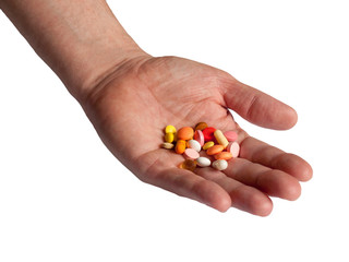Doctors hand holding many colorful pills isolated on white background. Drugs, medication addiction. Drug abuse and dependency