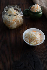 Homemade sauerkraut, pickled cabbage and carrots. Copy space.