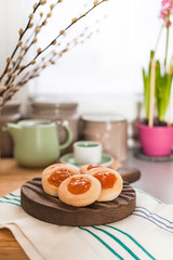 Still life with homemade cookies with jam and fresh coffee on the table near with flowers. Breakfast in the interior of the kitchen at home. Lifestyle, vintage photo.