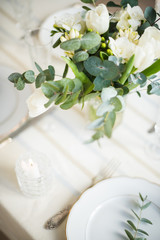 Beautiful festive table setting with elegant white flowers and cutlery, dinner table decoration 