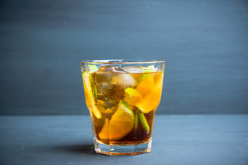 Cuba libre cocktail with cola and lime. Selective focus.