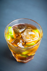 Cuba libre cocktail with cola and lime. Selective focus.