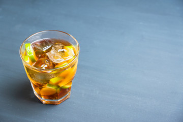 Cuba libre cocktail with cola and lime. Selective focus.