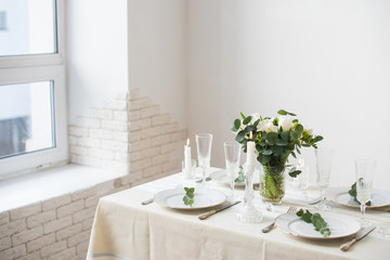 Beautiful festive table setting with elegant white flowers and cutlery, dinner table decoration 
