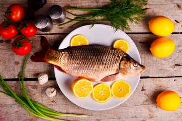 fresh fish Cyprinus carpio carpio with the vegetables  and lemon