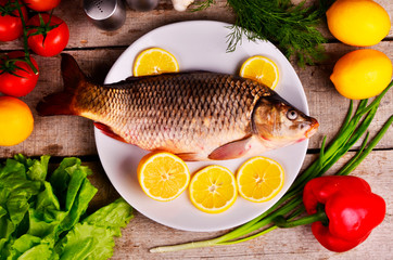 fresh fish Cyprinus carpio carpio with the vegetables  and lemon