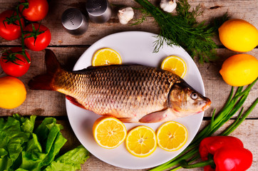 fresh fish Cyprinus carpio carpio with the vegetables  and lemon