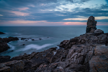 La Torche at dusk long exposure photo of rocks and sea