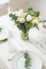 Beautiful festive table setting with elegant white flowers and cutlery, dinner table decoration 