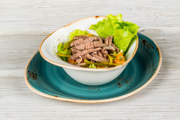 Salad with beef and gherkins close-up shot for menu