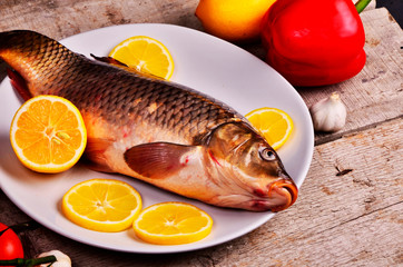 Fresh  fish and food ingredients on table