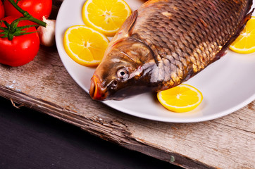 Fresh  fish and food ingredients on table