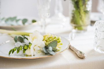 Beautiful festive table setting with elegant white flowers and cutlery, dinner table decoration 