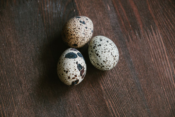 Textured spring background with small quail eggs. Eco products. Quail eggs on wooden background