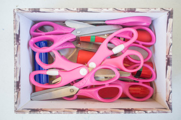 Box full of start children safety scissors and glue sticks