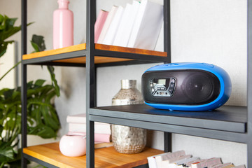Compact CD radio player on the shelf in the vintage interior of the living room