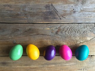 Colorful easter eggs on a wooden background. Copy space, horizontal orientation