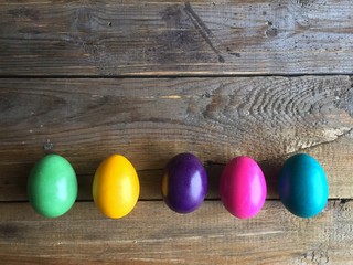 Colorful easter eggs on a wooden background. Copy space, horizontal orientation