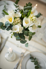 Beautiful festive table setting with elegant white flowers and cutlery, dinner table decoration 