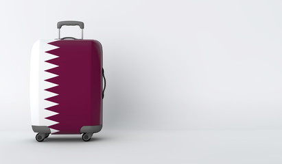 Travel suitcase with the flag of Qatar. Holiday destination. 3D Render
