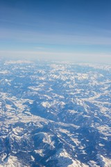 Fototapeta premium Aerial view of snow covered mountains - snowy mountain peaks - high mountains - Alps