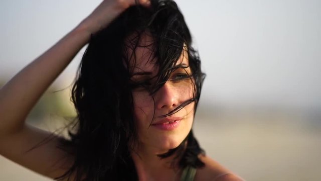 Outdoor fashion video of beautiful happy woman at sea. Beach travel.Slow motion.