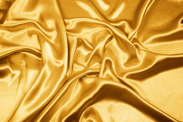 Gold luxury satin fabric texture for background