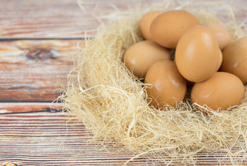 Eggs in wooden bowl on table.  Food concept