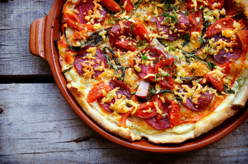 pizza with bacon, salami and vegetables