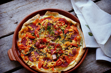 pizza with bacon, salami and vegetables