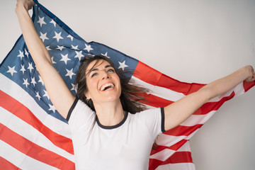 Fototapeta premium Happy woman with flag of the United States