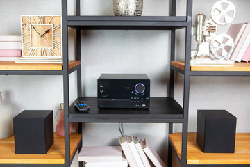 Compact CD radio player on the shelf in the vintage interior of the living room