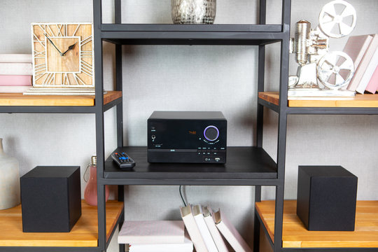 Compact CD radio player on the shelf in the vintage interior of the living room